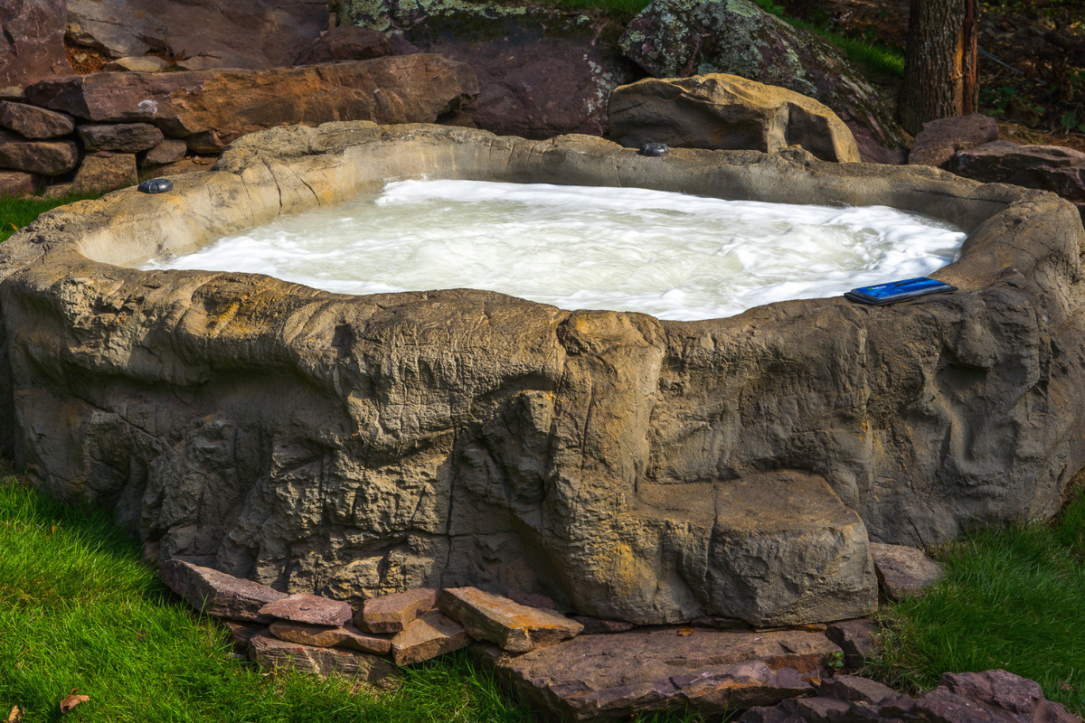 Photo of Universal Rocks Semi In-Ground Spa - Earth - Marquis Gardens